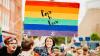 Woman holding a Love is Love flag