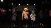 Seven masked performers of the One Hand Puppet Group perform to the forum