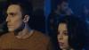 Man and woman stare into the distance in nightclub