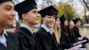 Asian student in a row smiling in his graduation ceremony