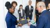 Woman handing document to Prince Charles