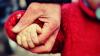 Elderly man and young child holding hands