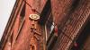 Lantern hanging from a brick building