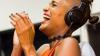 Candice Mama wearing headphones and laughing 
