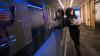 Woman using a laptop in an office hallway