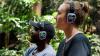 A man and a lady with headphones outside