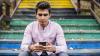boy using phone on coloured stairs
