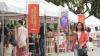 A woman walks by the stalls at the Design Fair.