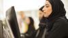 Lady with head covering works at computer