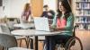 Student in wheelchair studies at laptop
