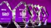 Five clear glass trophies, in a rough hexagonal shape, with white lettering that says: ELTons winner Local Innovation. Trophies sit on a black ground, against a purple background.