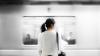 Woman standing on a train platform as a train arrives