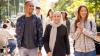 Group of diverse international students walking and interacting with each other at a university campus