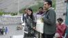 Fozia Tahir standing next to a man holding cloth bags.