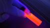 Scientist holding a glowing stick 