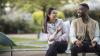 Two people sitting on a bench