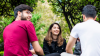 Image of three young people sitting outdoors