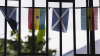 Four flags fly outside a window demonstrating the partnership between Scotland and Ghana
