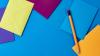 Colourful envelopes and a pencil