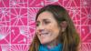 Kate Ewart-Biggs in front of a pink background