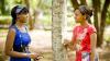 Two ladies outdoors speaking to each other
