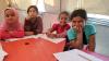 four little girls at a table
