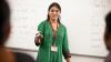 Teacher standing in front of a whiteboard.