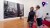 People viewing a large artwork in a gallery.