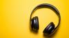 Black headphones on a yellow surface