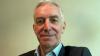 Headshot of Mark Walker, Executive Director of English & Exams and Global Director of English, wearing black jacket and pale blue shirt