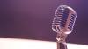 Metal microphone against a dark background