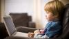 Child using laptop at home