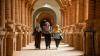 Three young women walk along a corridor in a university building in Sudan