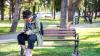 Woman sitting on a bench writing in a notepad