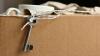 Cardboard box with coffee mug and house key 