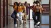 A group of young people dancing beside their school lockers