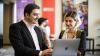 Young man and woman looking into the laptop screen