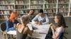 5 people in a meeting at a library