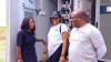 Three people engaged in a conversation.