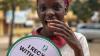 A child holding a placard.