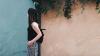 Woman standing by a wall