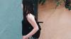 Woman standing by a wall