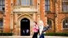Two students walking past a university building