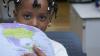 A young girl holding a globe