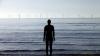 human sculpture looking out to sea