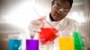 Young scientist mixing chemicals in a laboratory