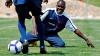 A young person tackling another during a football game