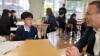 A students chats with Scott McDonald in his classroom.