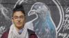 Pidgeon Pagonis standing in front of a drawing of a pigeon 