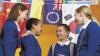 Four pupils chat together under flags of different countries